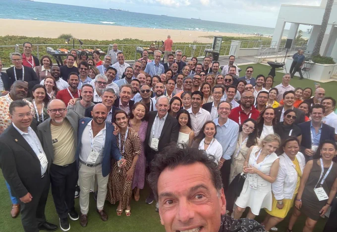 Crowd of people smiling outdoors