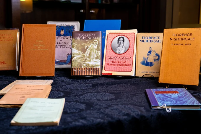 A collection of books about Florence Nightingale is displayed on a table, featuring various covers and titles.