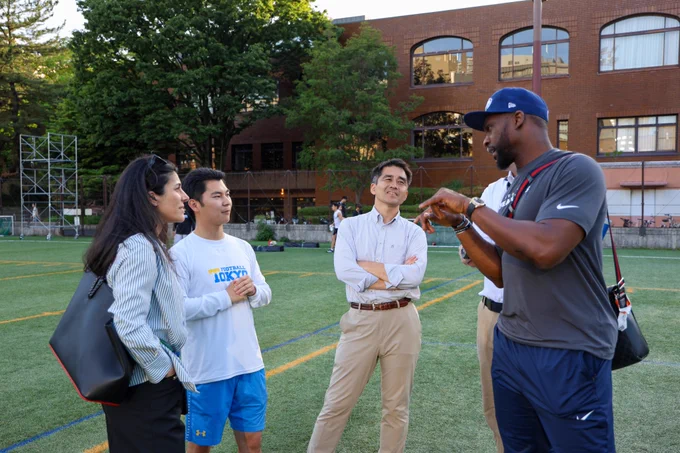 Retired Seahawk DE Cliff Avril stands with Seahawks representative and the Univ. of Tokyo football QB coach.