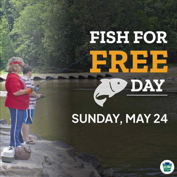 Two people fishing by a riverbank surrounded by trees promoting Fish for Free Day on Sunday, May 24.