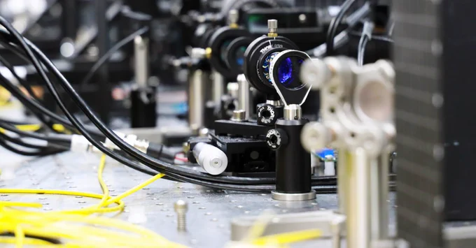 Fiber optic cables and optical equipment on a quantum research optical table at the University of Chicago.