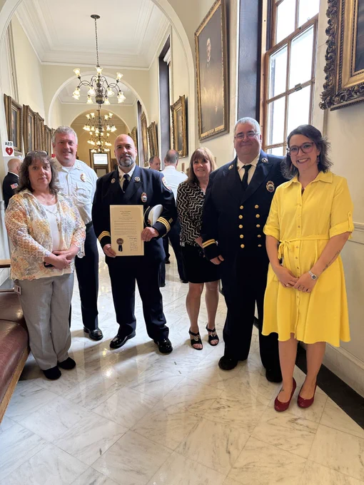 A group of Division employees with the signed proclamation from the Governor at the State House.