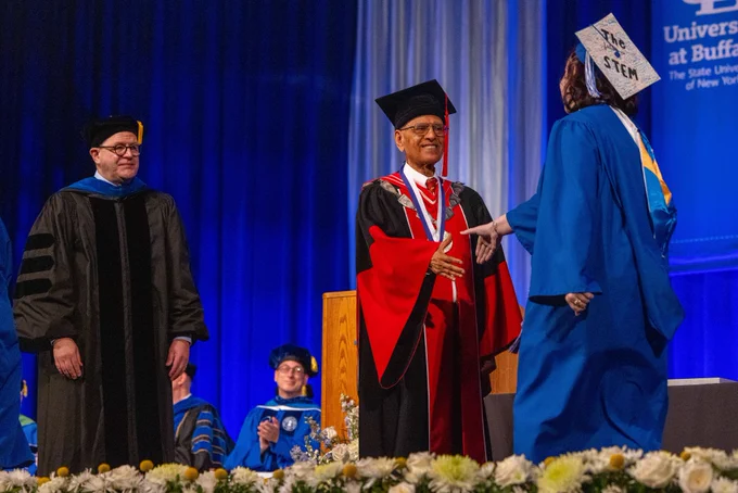 President Tripathi congratulates a graduate during commencement activities. 