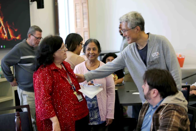 Pictured is a photo of U T A Libraries staff member Donna Kelley talking with another staff member at her retirement party.