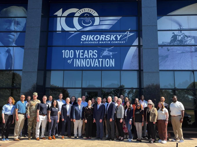 Connecticut state officials pose in front of the Sikorsky offices in Stratford, Connecticut during a state infrastructure tour. 