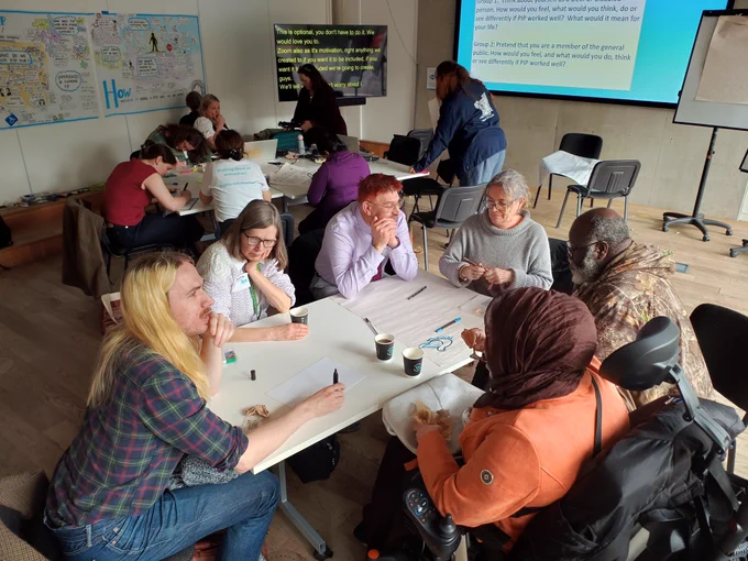 Participants at our Timms Review event sat around a table having a conversation.