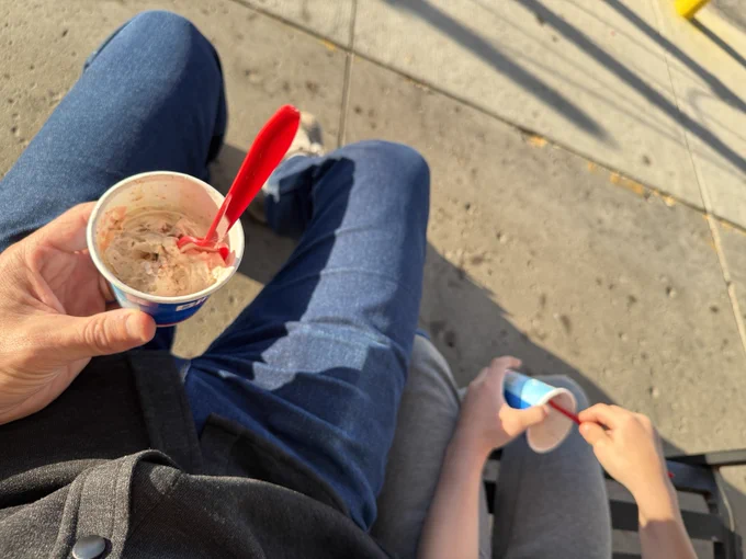 A photo of Rob Sand and his son eating Dairy Queen. 