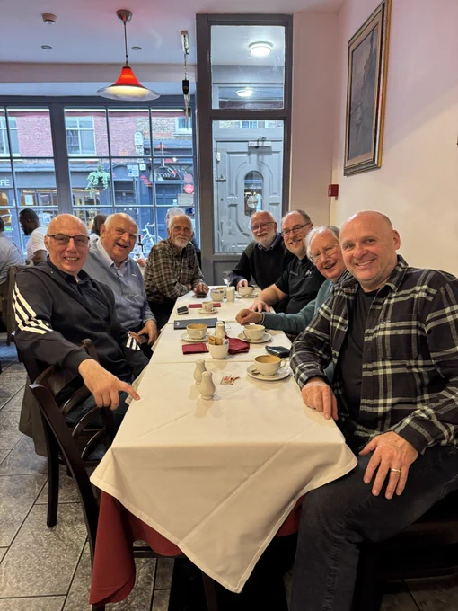 People sitting around a table in a restaurant, from front left around to front right:
Andy Pope
Roger Govier
Bob Philips
Bill Manville
Ken Puls
Charles Williams
Nick Hodge