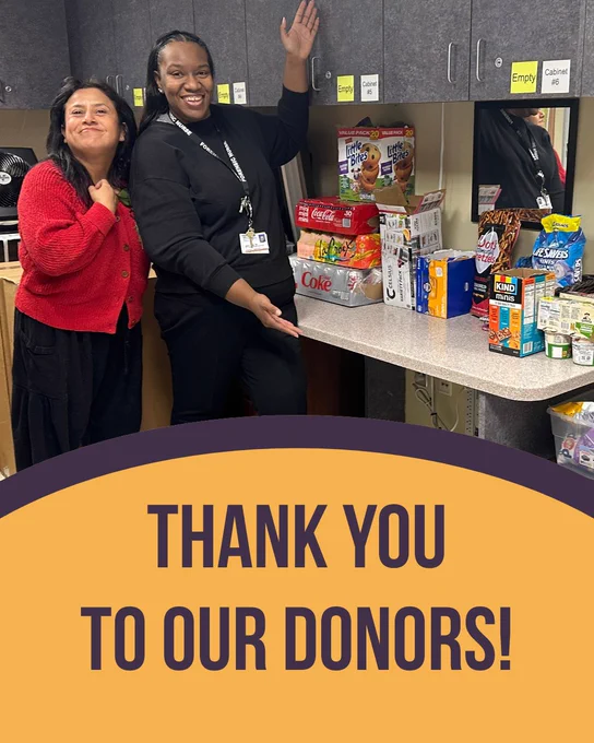 Two DCFNE staff members pose with a collection of donated snacks and refreshments. Text reads, "Thank you to our donors!"