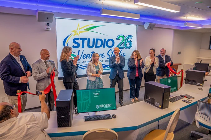 The Studio 26 ribbon-cutting ceremony. The ribbon is cut and attendees are clapping