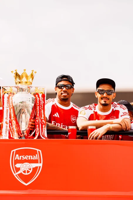 Creators Club photography of Gabriel and William Saliba next to the Premier League trophy on the bus during the parade