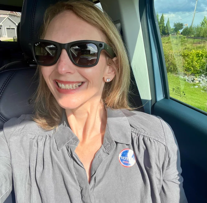 Kimberly- a white woman smiles in a selfie with her I voted sticker.