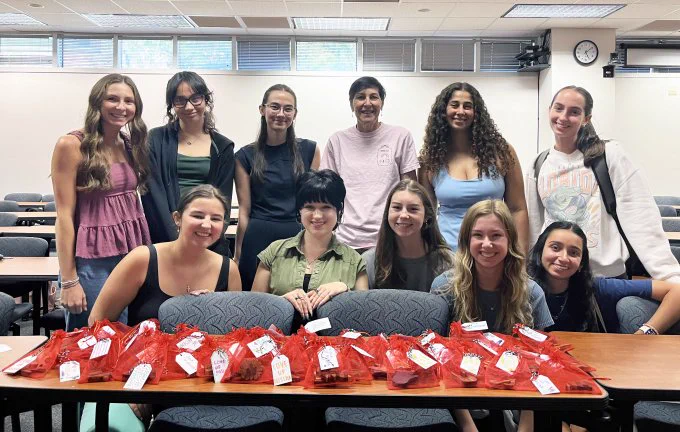 U F P H H P Clinical Assistant Professor Doctor Sharon DiFino and members of the U F chapter of the National Student Speech Language Hearing Association with packaged comfort symbols ready for delivery to patients receiving cancer treatment.
