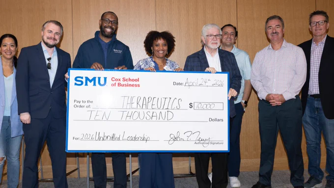 The winning SMU Cox School of Business Executive MBA student team in the Unbridled Venture Project pitch competition poses with their oversized check award, faculty and judges.