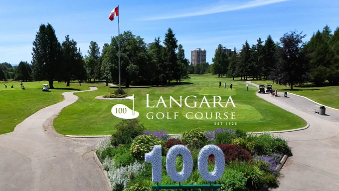 An aerial view of Langara Golf Course on a sunny day overlayed with the Langara Golf Course 100th anniversary logo