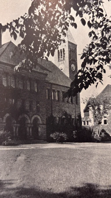 Cornell's Uris Library and McGraw Tower, as seen in 1926, surrounded by leafy trees and a well-kept lawn. The structure features arched windows and a brick exterior.