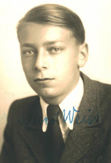 Vintage black-and-white portrait of a young man in formal attire.