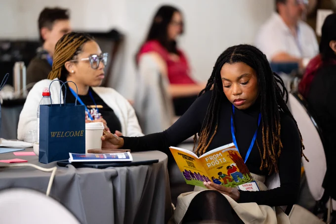 People sitting at a table taking notes