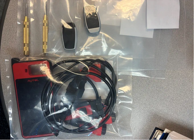 Items seized during the attempted break in of vehicles. Two center punch tools, two key fobs, one automobile scanner/programmer.