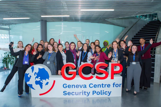 Participants in the course posing behind the GCSP logo