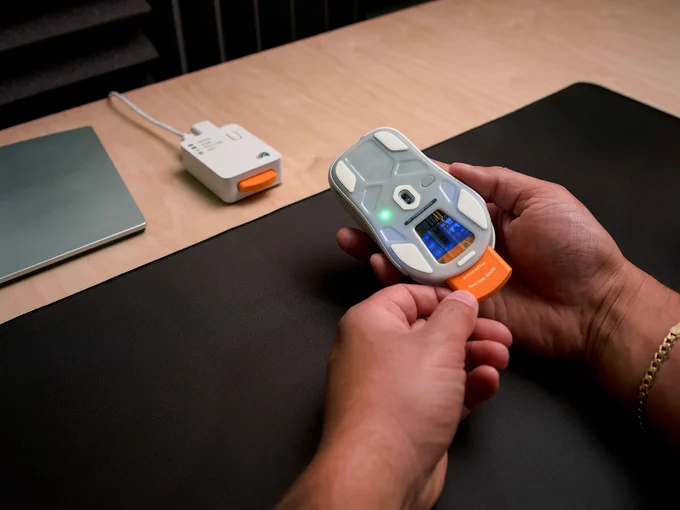 Model O3 Wireless mouse with hot-swap battery being removed