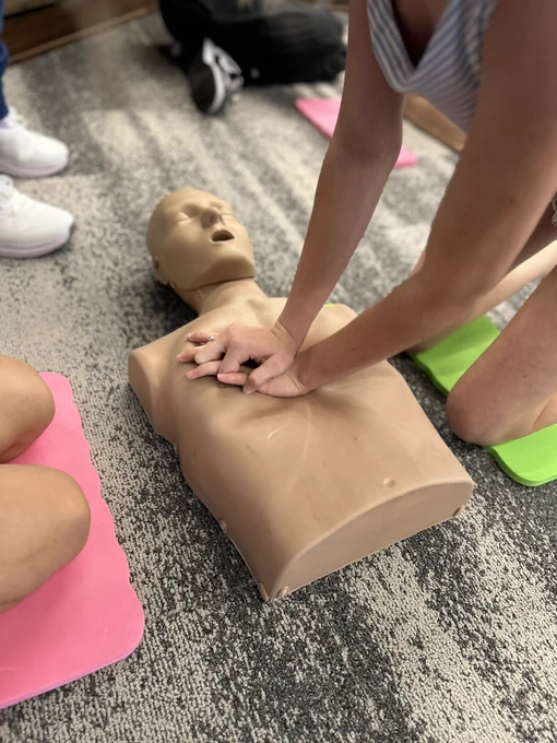 Participants in our Babysitter Program learning CPR