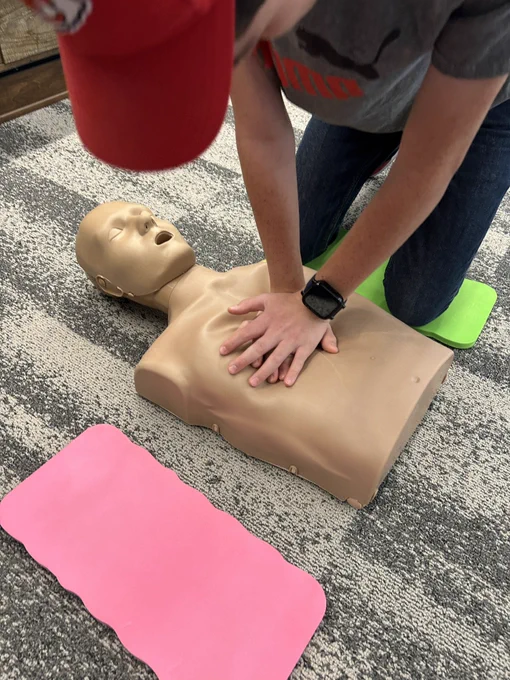 Participants in our Babysitter Program learning CPR