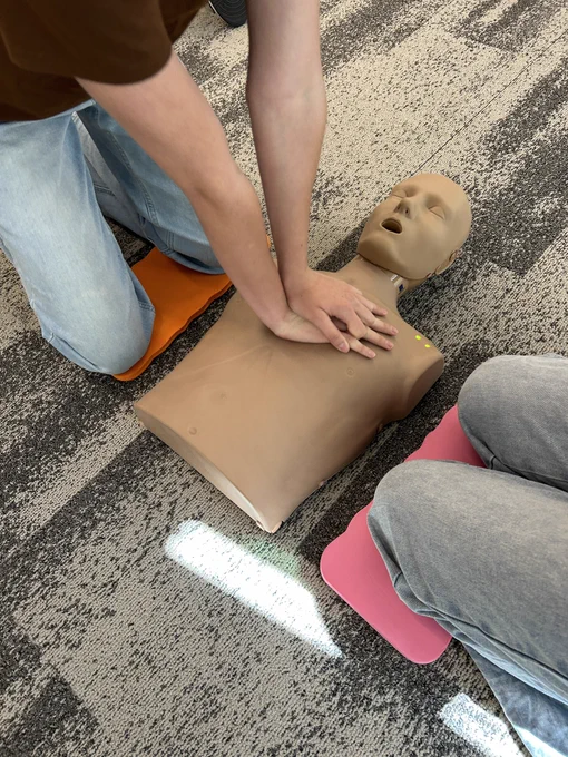 Participants in our Babysitter Program learning CPR