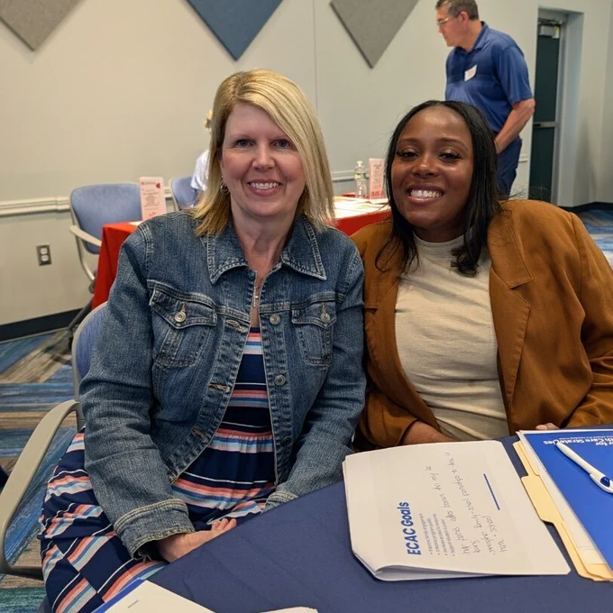 Two teachers together at a conference table
