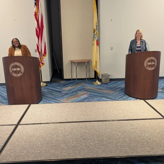 Teachers standing behind podiums