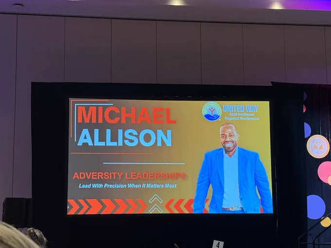 A slide image of Michael Allison, Purple Heart Veteran and leadership strategist on the projector screen.