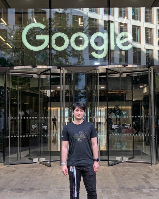 Irakli standing outside below a Google sign.