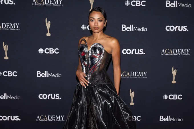 A woman standing on red carpet. 