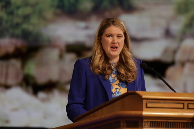 Elysa M. Dishman speaks at a podium at BYU Devotional, June 2026