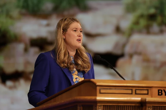 Elysa M. Dishman speaks at a podium at BYU Devotional, June 2026