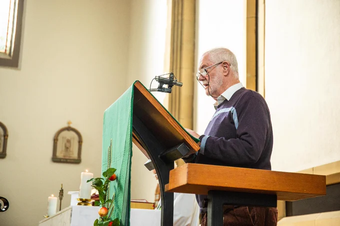 A volunteer stood up and speaking at Mass. 