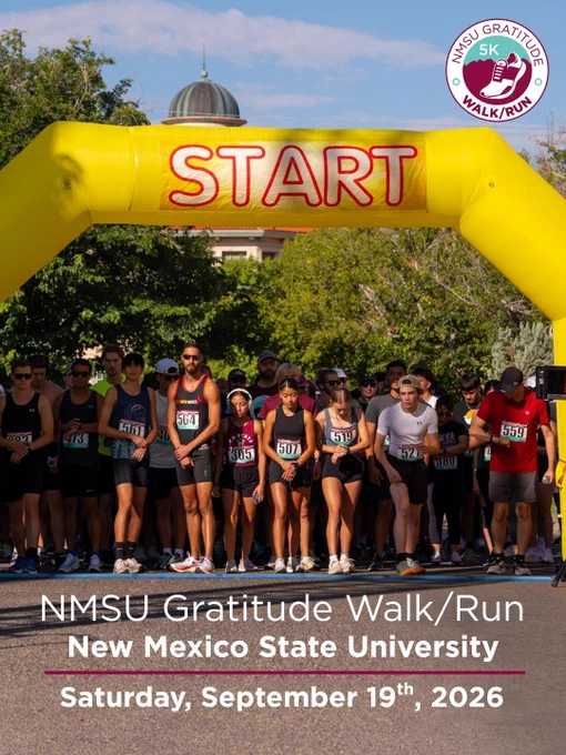 Participants gather at the starting line beneath an inflatable arch labeled "START" at the NMSU Gratitude Walk/Run. The event is held at New Mexico State University on Saturday, September 19th, 2026.