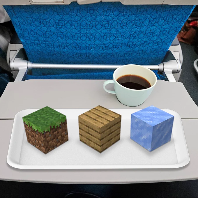 An airline food tray with Minecraft blocks & a cup of coffee