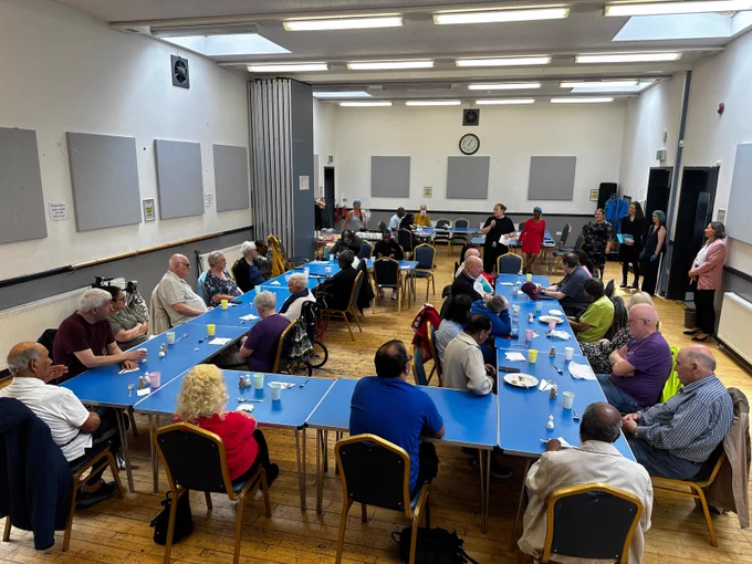 We see a photograph of volunteers, members, and community partners at having lunch at Bedford Hall this afternoon. Nicola Newman (Croydon Vision CEO) shares a few words of gratitude and thanks our volunteers for their brilliant support. It was a lovely afternoon. 