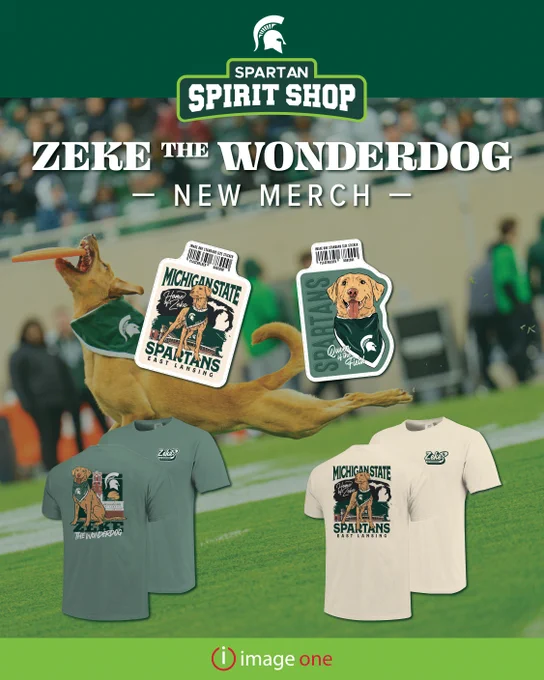 Image of merchandise featuring "Zeke the Wonderdog" at the Spartan Spirit Shop. Includes two T-shirts with designs of Zeke and logos, and two dog-shaped stickers. The background shows a blurred sports event and a jumping dog.