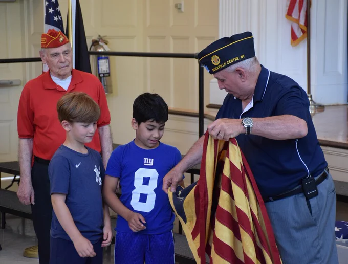 Bayville Intermediate students handle the Betsy Ross flag.