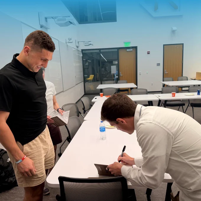 Guest speaker Colin Hodge signing his book for a Summer Founders Program team member.