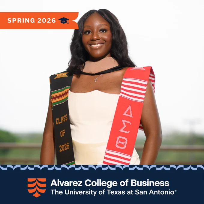 Ledeema Bagosbah wearing a white dress with a black and red kente stole, celebrating Spring 2026 at Alvarez College of Business.