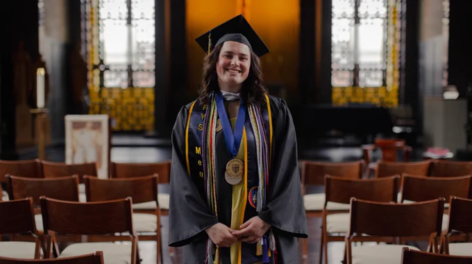 Emily Hanrahan ’26 stands in a chapel at Merrimack College.