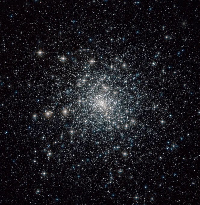 M30. A spherical collection of stars shines against black space, more closely concentrated at center.