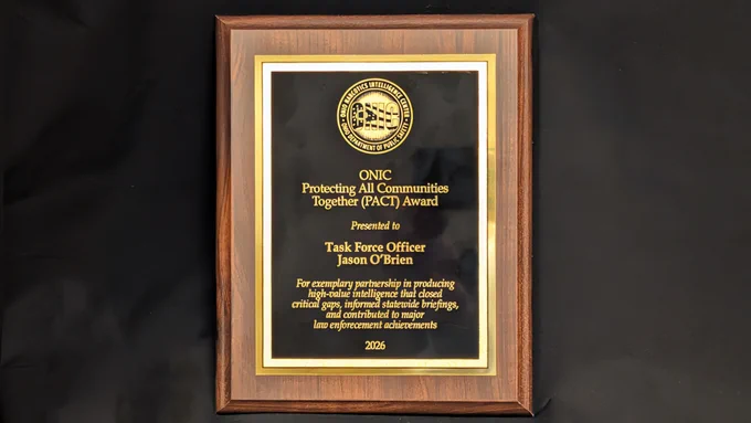Wood-framed plaque awarded to Task Force Officer Jason O'Brien for excellence in  partnerships in 2026.
