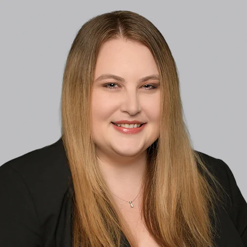 Headshot of Certified Specialist in Franchise & Distribution Law Caitlyn Dillon on a light gray background.