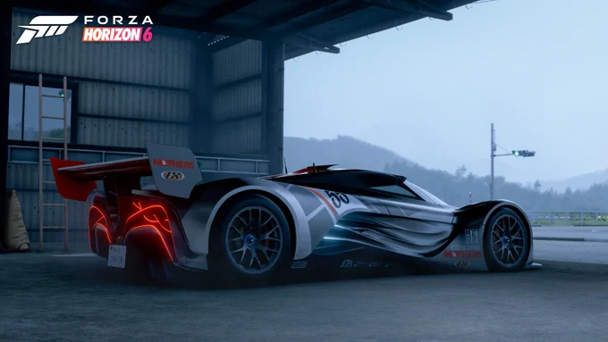 A sleek, futuristic race car with the number 98 is parked inside a spacious garage with an open view to a misty landscape. The car features noticeable curves and glowing red lights at the rear. "Forza Horizon 6" is prominently displayed in the top left corner.