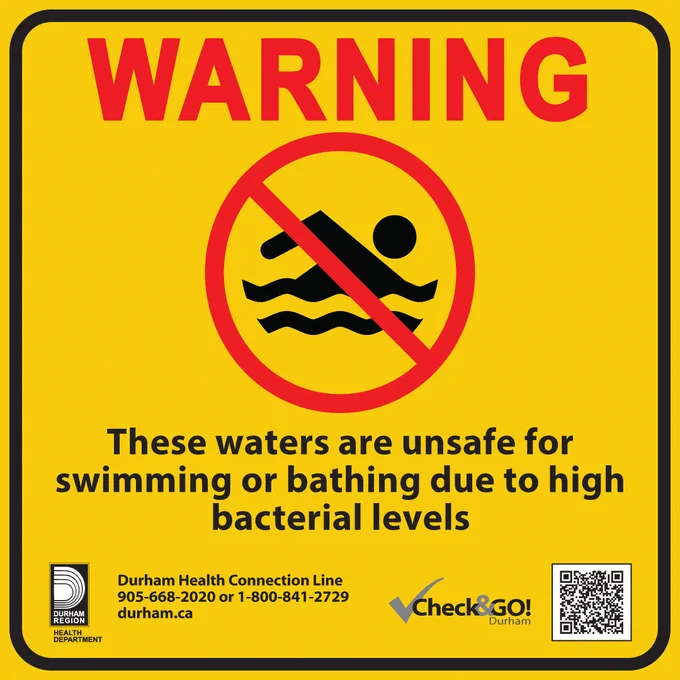 Warning sign indicating waters are unsafe for swimming or bathing due to high bacterial levels. Features a drowning hazard symbol. Includes contact details for the Durham Health Connection Line and Check&GO! Durham logos.