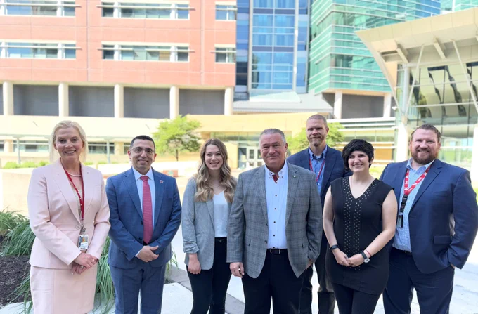 Group from UNMC Department of Pathology, Microbiology and Immunology standing with Rep. Don Bacon in front of DRC 2 building. From left, Drs. Alison Cushman-Vokoun, Joseph Khoury, Holly Mitzel, Rep. Bacon, and Drs. Scott Koepsell, Marika Forsythe and Jesse Cox.
